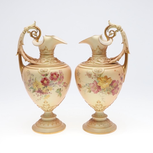 800 - LARGE PAIR OF ROYAL WORCESTER EWERS. A pair of blush ivory ewers, with acanthus shaped handle and th... 