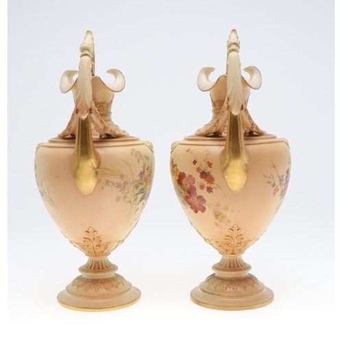 800 - LARGE PAIR OF ROYAL WORCESTER EWERS. A pair of blush ivory ewers, with acanthus shaped handle and th... 