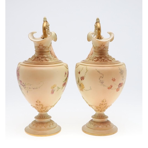 800 - LARGE PAIR OF ROYAL WORCESTER EWERS. A pair of blush ivory ewers, with acanthus shaped handle and th... 