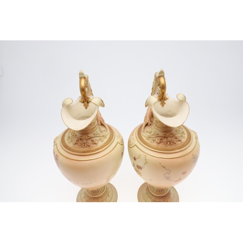 800 - LARGE PAIR OF ROYAL WORCESTER EWERS. A pair of blush ivory ewers, with acanthus shaped handle and th... 