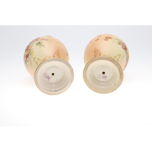 800 - LARGE PAIR OF ROYAL WORCESTER EWERS. A pair of blush ivory ewers, with acanthus shaped handle and th... 