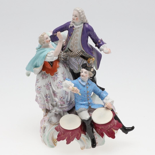 820 - MEISSEN PORCELAIN FIGURE GROUP. 19thc, modelled as a gallant standing on scrolled rockwork, with a m... 