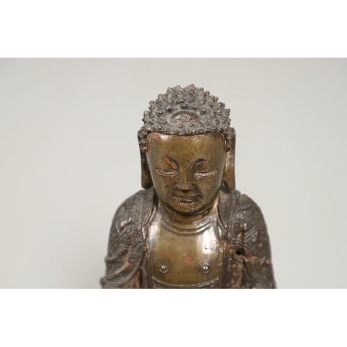 840 - EARLY CHINESE BRONZE BUDDHA. Possibly Ming Dynasty, the figure sat in contemplation on a lotus leaf ... 