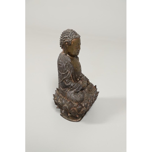 840 - EARLY CHINESE BRONZE BUDDHA. Possibly Ming Dynasty, the figure sat in contemplation on a lotus leaf ... 