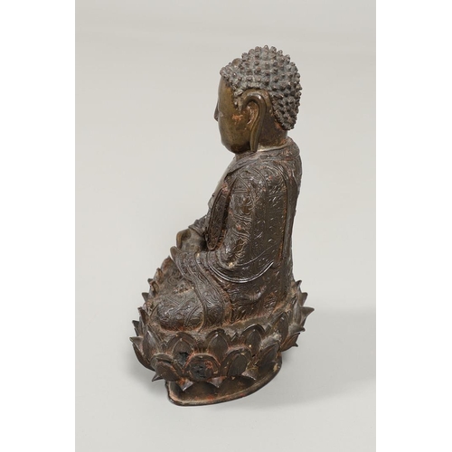 840 - EARLY CHINESE BRONZE BUDDHA. Possibly Ming Dynasty, the figure sat in contemplation on a lotus leaf ... 