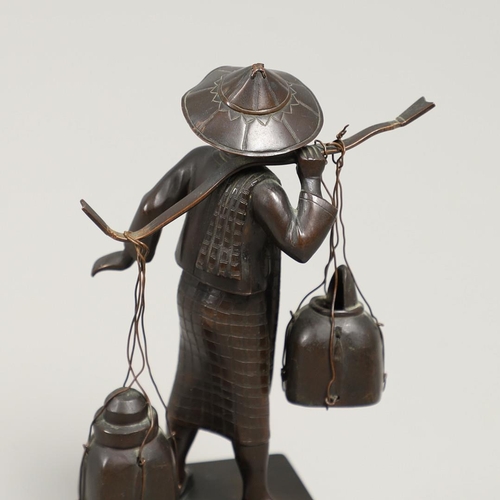 846 - SOUTH EAST ASIAN BRONZE FISHERMAN. A bronze figure of a Fisherman, carrying two storage jars suspend... 