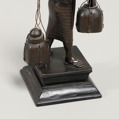 846 - SOUTH EAST ASIAN BRONZE FISHERMAN. A bronze figure of a Fisherman, carrying two storage jars suspend... 