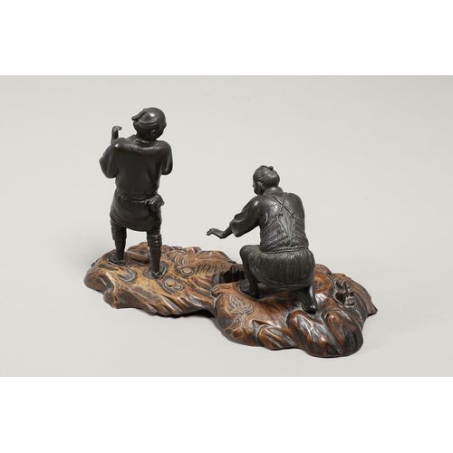 850 - JAPANESE BRONZE FIGURE GROUP & CARVED WOODEN STAND. Meiji period, including two detailed bronze figu... 