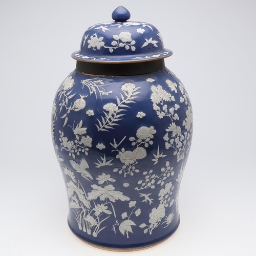 867 - LARGE CHINESE PORCELAIN LIDDED JAR. Probably 19thc, with a white slip in low relief and painted with... 