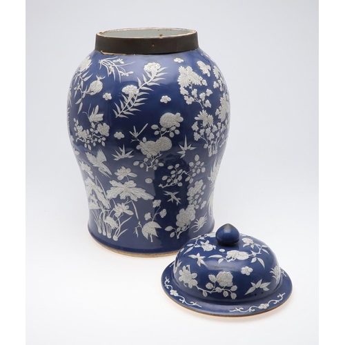 867 - LARGE CHINESE PORCELAIN LIDDED JAR. Probably 19thc, with a white slip in low relief and painted with... 