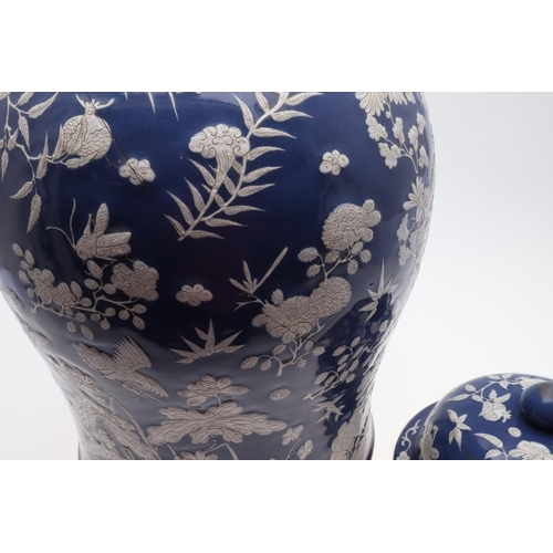 867 - LARGE CHINESE PORCELAIN LIDDED JAR. Probably 19thc, with a white slip in low relief and painted with... 