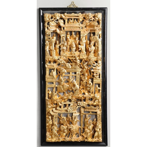 883 - LARGE CHINESE CARVED & GILDED WOODEN PANEL. A large rectangular wooden pierced panel, heavily carved... 