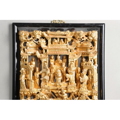 883 - LARGE CHINESE CARVED & GILDED WOODEN PANEL. A large rectangular wooden pierced panel, heavily carved... 