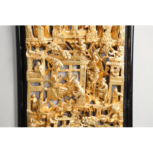 883 - LARGE CHINESE CARVED & GILDED WOODEN PANEL. A large rectangular wooden pierced panel, heavily carved... 