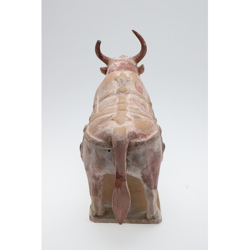 894 - CHINESE PAINTED POTTERY OX - NORTHERN QI DYNASTY (549-577). A large painted pottery model of an Ox, ... 