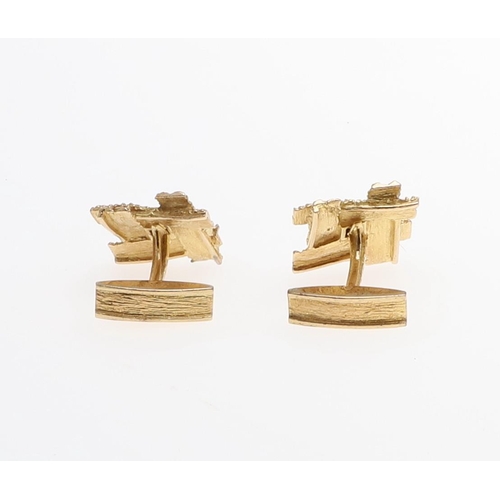 1038 - A PAIR OF GOLD AND DIAMOND CUFFLINKS. each link of textured abstract form and centred with a circula... 