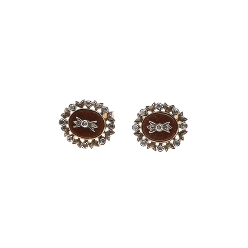 1039 - A PAIR OF DIAMOND AND GOLDSTONE CUFFLINKS. each cufflink set with an oval section of goldstone with ... 