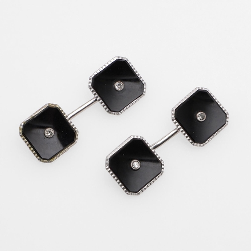 1041 - A PAIR OF BLACK ONYX AND DIAMOND CUFFLINKS. each octagonal-shaped black onyx link centred with a sin... 