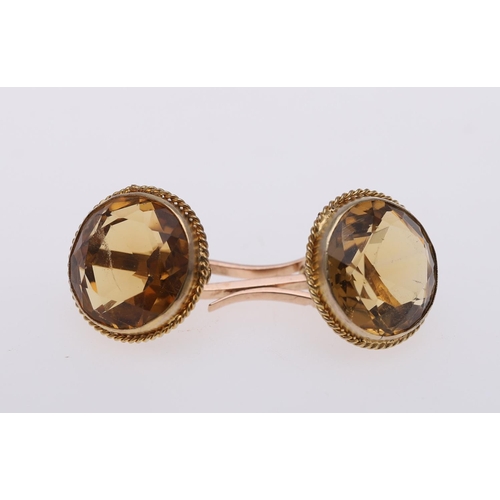 1042 - A PAIR OF CITRINE & GOLD CUFFLINKS. each link mounted with a circular-cut citrine, in gold mounts.  ... 