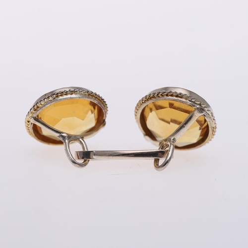 1042 - A PAIR OF CITRINE & GOLD CUFFLINKS. each link mounted with a circular-cut citrine, in gold mounts.  ... 