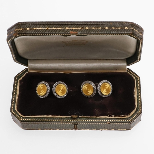 1044 - A PAIR OF DIAMOND AND ENAMEL CUFFLINKS BY CARTIER. each formed with a circular section of yellow gui... 