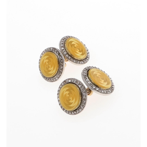 1044 - A PAIR OF DIAMOND AND ENAMEL CUFFLINKS BY CARTIER. each formed with a circular section of yellow gui... 