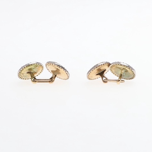 1044 - A PAIR OF DIAMOND AND ENAMEL CUFFLINKS BY CARTIER. each formed with a circular section of yellow gui... 