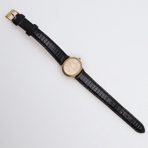 1046 - A LADY'S GOLD WRISTWATCH BY ASPREY. the signed oval-shaped dial with baton numerals and date apertur... 