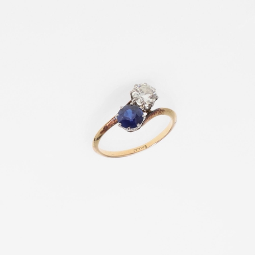 1053 - A SAPPHIRE AND DIAMOND TWO STONE CROSS-OVER RING. mounted with a circular-cut sapphire and a circula... 