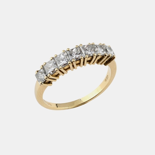 1055 - A DIAMOND HALF HOOP RING. mounted with seven princess-cut diamonds in 18ct yellow gold. Size Q.  *CR... 