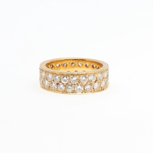 1061 - A DIAMOND FULL CIRCLE ETERNITY RING. mounted with two rows of brilliant-cut diamonds, in yellow gold... 