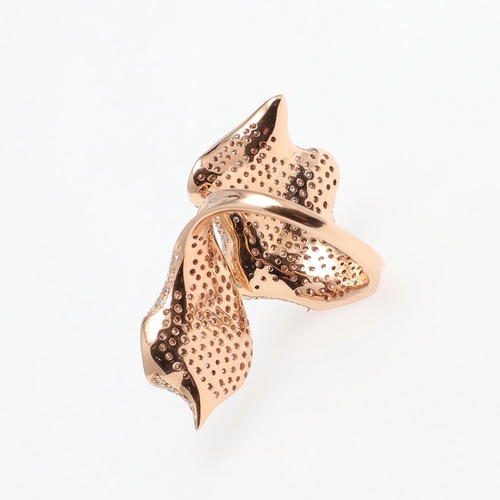 1065 - AN 18CT ROSE GOLD AND DIAMOND RING. of stylised foliate design, mounted overall with circular-cut di... 