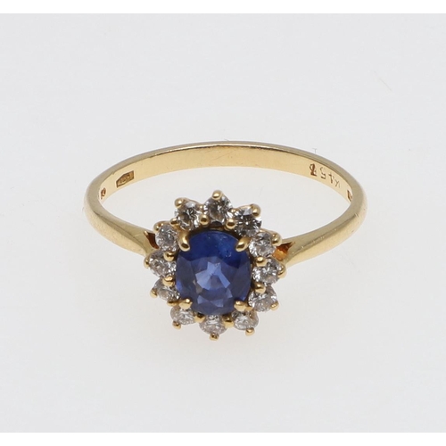 1067 - A SAPPHIRE AND DIAMOND CLUSTER RING. the oval-shaped sapphire is set within a surround of circular-c... 