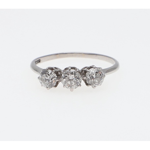 1068 - A DIAMOND THREE STONE RING. mounted with three old-cut diamonds, in platinum. Size Q 1/2.  *CR  All ... 