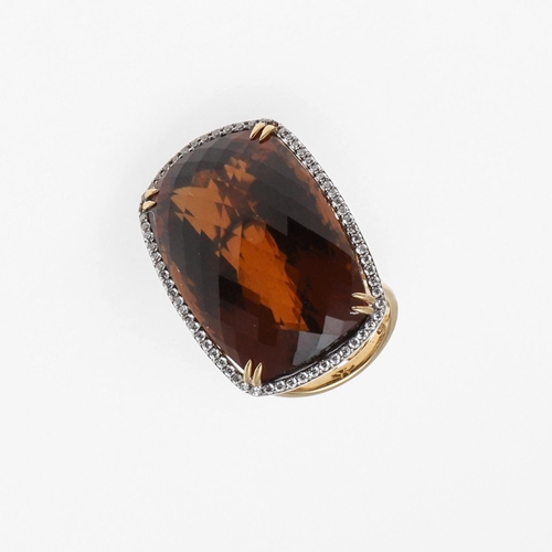 1069 - A CITRINE AND DIAMOND COCKTAIL RING. the large rounded rectangular-shaped citrine is set within a su... 