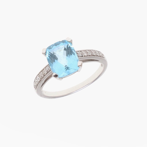 1071 - A BLUE TOPAZ AND DIAMOND RING. the rounded rectangular-shaped blue topaz is set with circular-cut di... 