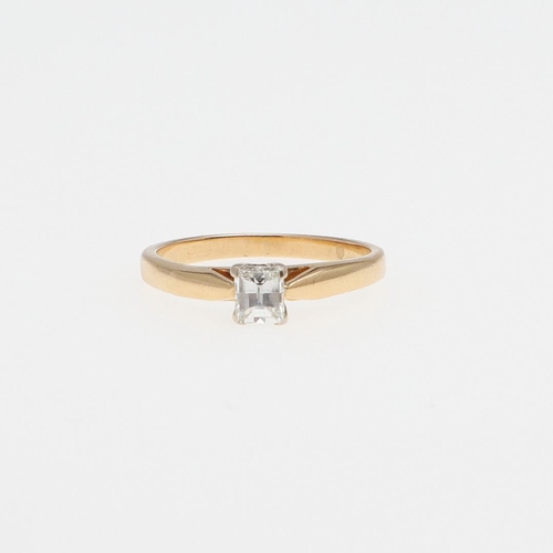 1073 - A DIAMOND SOLITAIRE RING. the rectangular-shaped diamond is set in 18ct gold, 2.4 grams. Size I 1/2.... 