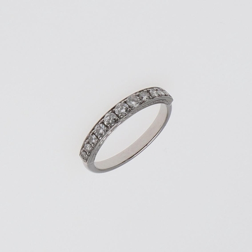 1079 - A DIAMOND HALF HOOP RING. mounted with eleven graduated circular-cut diamonds, 3.2 grams. Size J 1/2... 