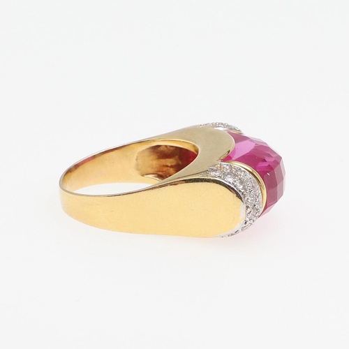 1276 - A SYNTHETIC PINK SAPPHIRE AND DIAMOND RING. the faceted synthetic pink sapphire is set with two rows... 