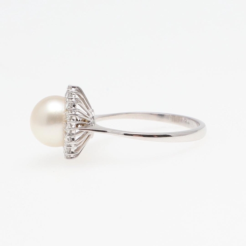 1277 - A CULTURED PEARL AND DIAMOND CLUSTER RING. the cultured pearl measures approximately 9.2mm and is se... 