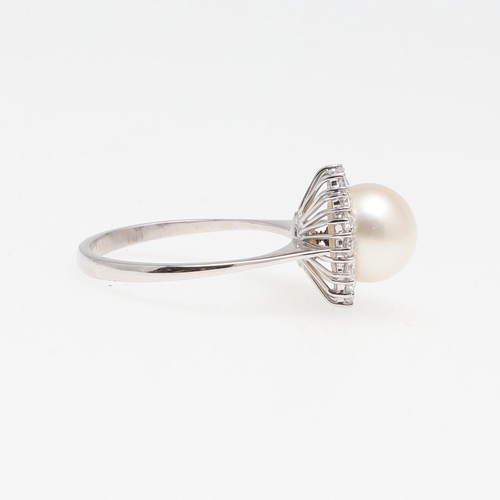 1277 - A CULTURED PEARL AND DIAMOND CLUSTER RING. the cultured pearl measures approximately 9.2mm and is se... 