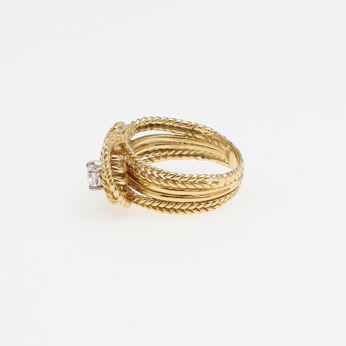 1279 - A DIAMOND AND GOLD RING. of woven gold knotted design, set with two brilliant-cut diamonds, 7.9 gram... 