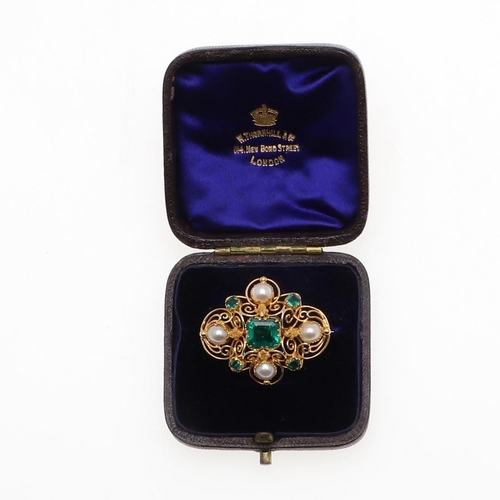 1282 - AN EMERALD, PEARL AND GOLD BROOCH. the gold openwork mount is centred with a rectangular-shaped emer... 