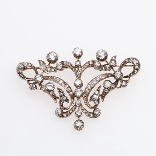 1283 - A VICTORIAN DIAMOND BROOCH. of openwork foliate scrolling design, set overall with graduated old-cut... 