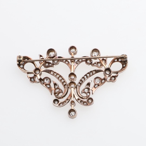 1283 - A VICTORIAN DIAMOND BROOCH. of openwork foliate scrolling design, set overall with graduated old-cut... 