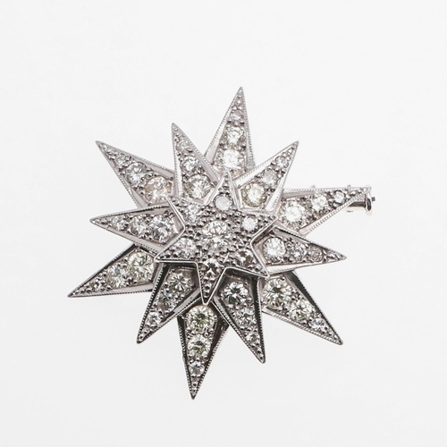 1285 - A DIAMOND STAR BROOCH. mounted overall with graduated circular-cut diamonds in white gold, 3.5cm wid... 