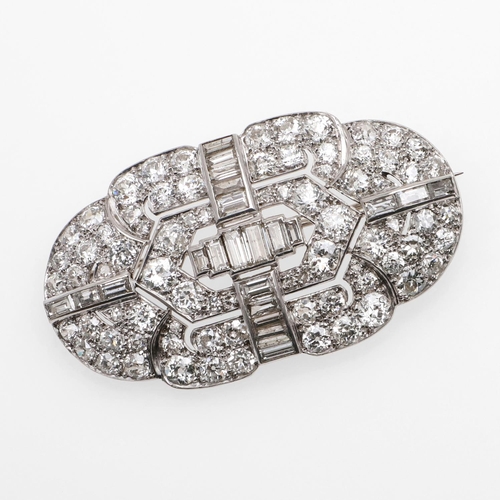 1289 - AN ART DECO DIAMOND BROOCH. the openwork design is centred with baguette-cut diamonds and millegrain... 