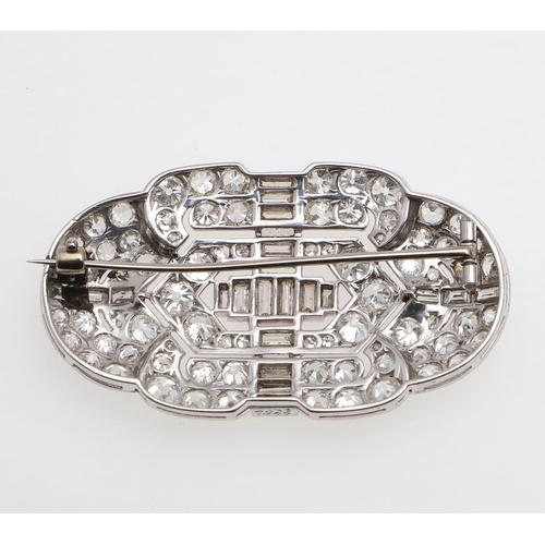 1289 - AN ART DECO DIAMOND BROOCH. the openwork design is centred with baguette-cut diamonds and millegrain... 