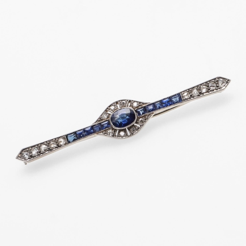 1291 - AN ART DECO SAPPHIRE AND DIAMOND BROOCH. the oval-shaped sapphire is set within a surround of circul... 