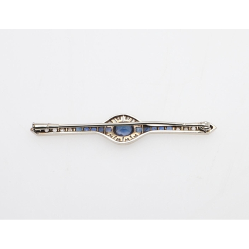 1291 - AN ART DECO SAPPHIRE AND DIAMOND BROOCH. the oval-shaped sapphire is set within a surround of circul... 